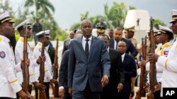 In this April 7, 2018, file photo, Haiti's President Jovenel Moise, center, leaves the museum during a ceremony marking the 215th anniversary of revolutionary hero Toussaint Louverture's death, at the National Pantheon museum in Port-au-Prince, Haiti. (AP