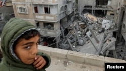 FILE - A Palestinian boy reacts near the site of an Israeli strike on a house in Rafah, Gaza Strip, March 24, 2024. Children in war zones around the world are not receiving lifesaving humanitarian aid, a senior U.N. official said on April 3, 2024.