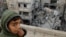 FILE - A Palestinian boy reacts near the site of an Israeli strike on a house in Rafah, Gaza Strip, March 24, 2024. Children in war zones around the world are not receiving lifesaving humanitarian aid, a senior U.N. official said on April 3, 2024.