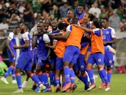 Haiti celebrates a 3-2 win over Canada in a CONCACAF Gold Cup soccer quarterfinal, June 29, 2019, in Houston.