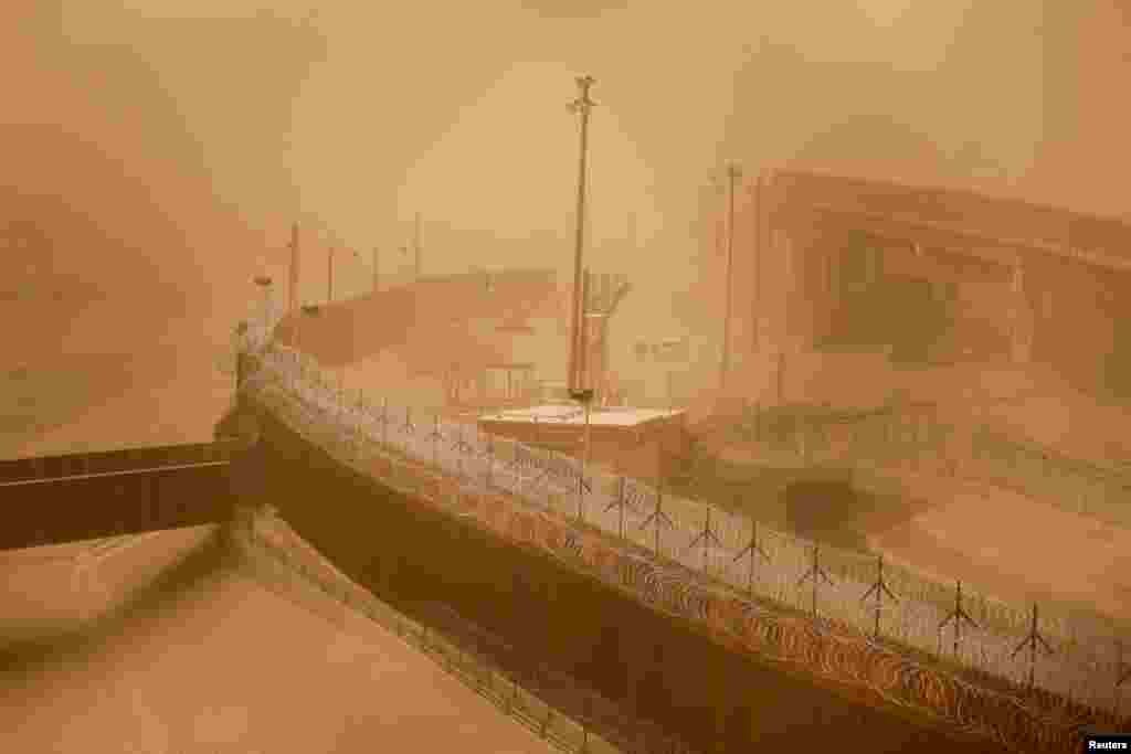 A sandstorm covers a section of the border wall in El Paso, Texas, as seen from Ciudad Juarez, Mexico, March 16, 2021.