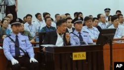 In this photo released by the Jinan Intermediate People's Court, former Politburo member and party leader of the megacity of Chongqing Bo Xilai, in the defendant seat listens to a testimony by former Chongqing city police chief Wang Lijun, unseen, at Jina