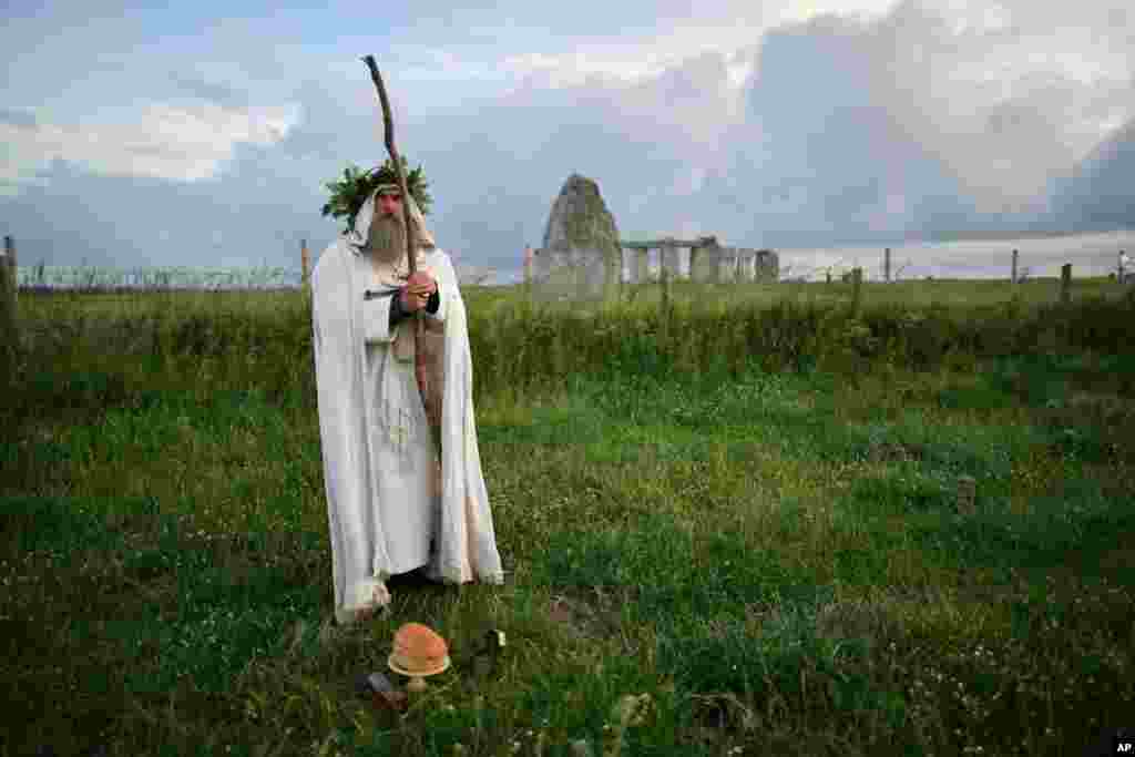 An Archdruid performs a ritual near to the cordoned off Stonehenge as a small group of people gathered to celebrate the Summer Solstice, the longest day of the year, near Salisbury, England.