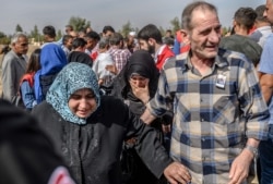 Syrian refugees and relatives of nine-month-old baby, Mohammed Omar, killed in a mortar attack a day earlier in Akcakale near northern Syria, leaves after funeral ceremony in Akcakale on Oct. 11, 2019.