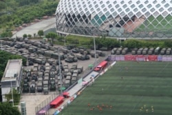 Chinese paramilitary vehicles are parked at the Shenzhen Bay Sports Center in Shenzhen near the border with Hong Kong, Aug. 17, 2019.