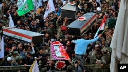 Mourners carry the coffins of Iran-backed Popular Mobilization Forces fighters killed in a U.S. airstrike in Qaim, during their funeral in Najaf, Iraq, Dec. 31, 2019. 