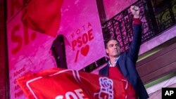 FILE - Spain's Prime Minister and Socialist Party leader Pedro Sanchez gestures to supporters outside the party headquarters following the general election in Madrid, Nov.10, 2019. 