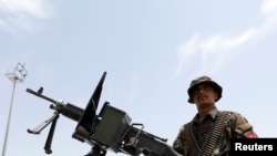 FILE - An Afghan security forces member keeps watch in an army vehicle in Bagram U.S. air base, after American troops vacated it, in Parwan province, Afghanistan, July 5, 2021. 