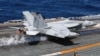 A U.S. navy F-18 Super Hornet takes off on the flight deck on the USS Nimitz, off the coast of Busan, South Korea, March 27, 2023. 