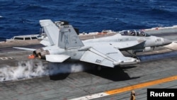 A U.S. navy F-18 Super Hornet takes off on the flight deck on the USS Nimitz, off the coast of Busan, South Korea, March 27, 2023. 