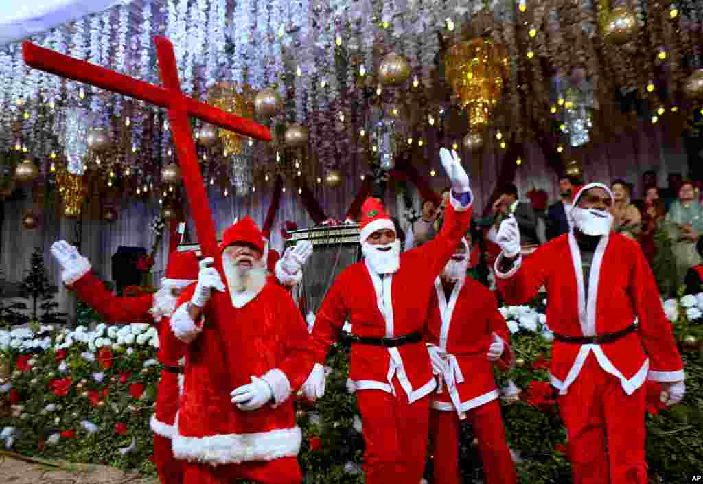 Pakistani Christians wear Santa Claus suits during a celebrations for Christmas, in Lahore.