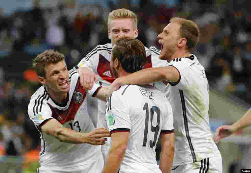 Germany's Mario Goetze (C) celebrates with teammates after scoring against Argentina during extra time in their 2014 World Cup final at the Maracana stadium in Rio de Janeiro July 13, 2014.