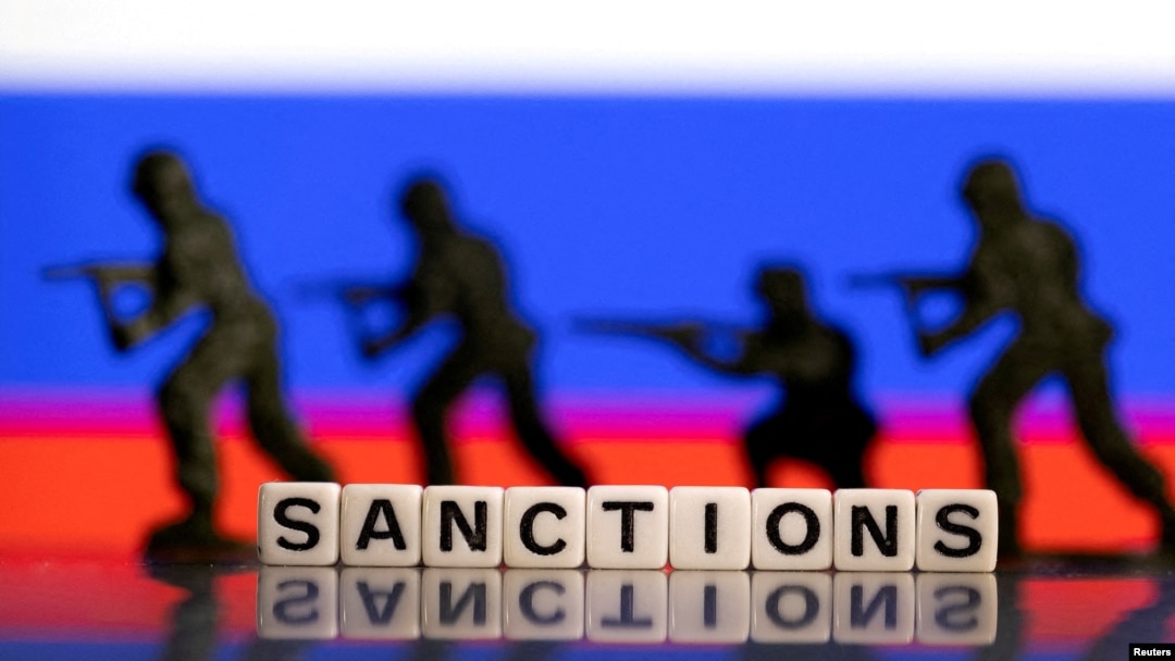 FILE PHOTO: Illustration shows plastic letters arranged to read "Sanctions" and solider toys are placed in front of Russia's flag colors