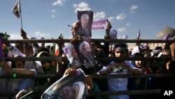 Supporters of Iranian President Hassan Rouhani in the May 19 presidential election attend his campaign rally, in Isfahan, Iran, Sunday, May 14, 2017.