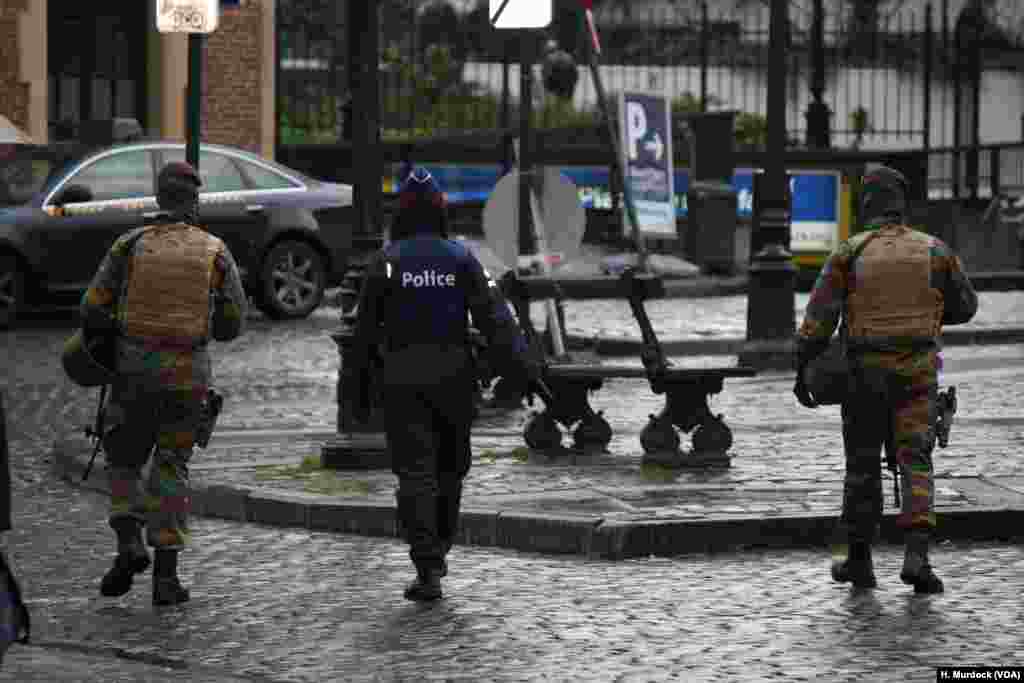 Security forces appear generally calm as they widen their search for men suspected of being involved in the Paris attacks, and possibly planning attacks in Brussels, Belgium.