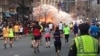 FILE - Runners continue to run towards the finish line of the Boston Marathon as an explosion erupts near the finish line of the race in this photo exclusively licensed to Reuters by photographer Dan Lampariello after he took the photo in Boston, Massachusetts, April 15, 2013.