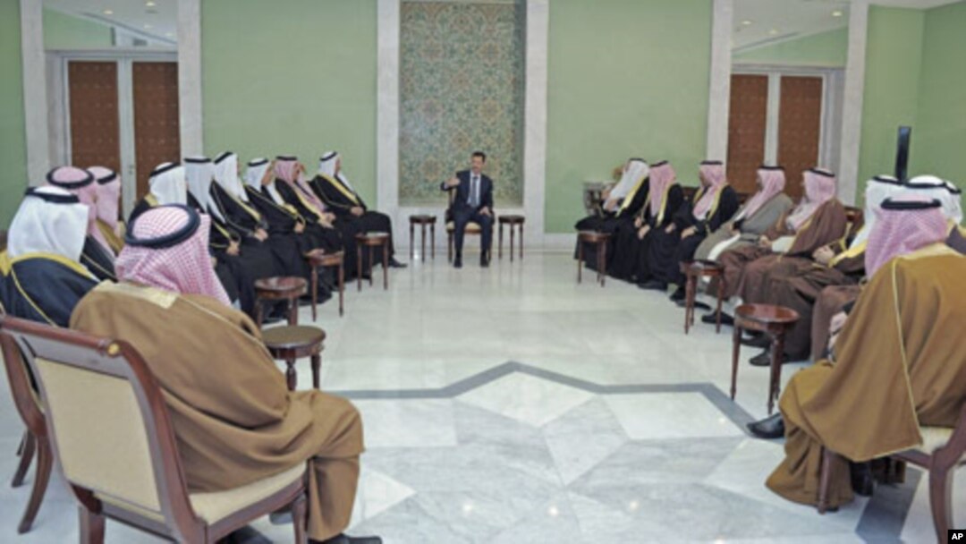 Syria's President Bashar al-Assad (C) meets a delegation of clan leaders from three cities in nation's northeastern region - Deir Ezzour, Raqqa and Hasaka - in Damascus, Syria, December 22, 2011.