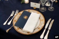 A table is set during a media preview for the State Dinner with President Joe Biden and French President Emmanuel Macron in the State Dining Room of the White House in Washington, Wednesday, Nov. 30, 2022. (AP Photo/Andrew Harnik)