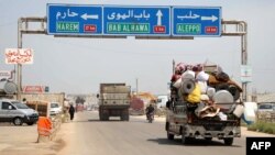 A truck is loaded with belongings of a family as they flee from reported regime shelling on Hama and Idlib provinces, May 1, 2019.