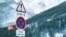 Road signs are pictured on a snow-covered road in Saint-Pancrace as winter weather bringing snow and freezing temperatures continues in France, March 2, 2018. The sign reads, "Avalanche risk." 