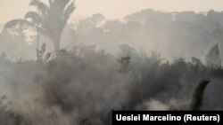 BRAZIL – Smoke billows during a fire in an area of the Amazon rainforest near Humaita, Amazonas State, on August 14, 2019. 