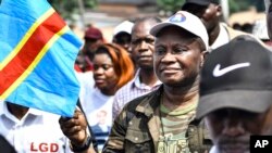 FILE—Cherubin Okende, a former transport minister and now a member of Together for the Republic, an opposition party, participate in an opposition protest in Kinshasa, Democratic Republic of the Congo, on March 11, 2023.