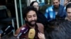 FILE - Journalist and activist Omar Radi speaks to the media outside court in Casablanca, Morocco, March 12, 2020. On July 29, 2024, Radi was pardoned after being detained since 2021 on sexual assault charges he denied. 