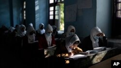 FILE - Afghan girls participate a lesson at Tajrobawai Girls High School, in Herat, Afghanistan, Nov. 25, 2021.