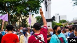 A protester holds up the three-finger salute, a sign of defiance, during anti-government protests in Bangkok, Thailand, June 26, 2021. (Tommy Walker/VOA)