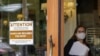 FILE - A sign reminds customers to wear masks at a bakery in Lake Oswego, Oregon, May 21, 2021. Oregon Gov. Kate Brown on Aug. 10 announced a statewide indoor mask requirement due to the spike in COVID-19 hospitalizations and cases.