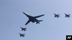 U.S. B-1 bomber, center, flies over Osan Air Base with U.S. jets in Pyeongtaek, South Korea, Tuesday, Sept. 13, 2016.