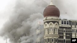 In this Saturday, Nov. 29, 2008 file picture, smoke billows from the landmark Taj Mahal hotel in Mumbai, India after an attack by gunmen