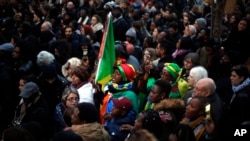 Protesters attend a demonstration against slavery in Libya outside the Libyan Embassy in Paris, Nov. 24, 2017. 