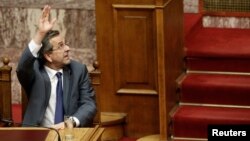Greece's Prime Minister Antonis Samaras votes during a parliament vote on a series of reforms, in Athens, July 18, 2013. 