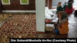 Panitia qurban Musholla An-Nur, Cibiru Hilir, Bandung, memasukkan daging ke ratusan besek yang dikumpulkan lewat “Patungan Besek”, Minggu, 11 Agustus 2019 siang. (Foto: Diar Sukandi/Musholla An-Nur)