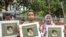 FILE - Bangladeshi women hold placards and photographs of schoolgirl Nusrat Jahan Rafi at a protest in Dhaka, April 12, 2019, following her murder by being set on fire after she had reported a sexual assault.