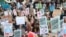 FILE - Students hold banners as they attend a climate school strike in London, Britain, Feb. 14, 2020.