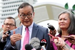 FILE - Sam Rainsy, self-exiled founder of the opposition Cambodia National Rescue Party (CNRP) and its deputy president, Mu Sochua, speak to members of the media in Kuala Lumpur, Malaysia, Nov. 12, 2019.