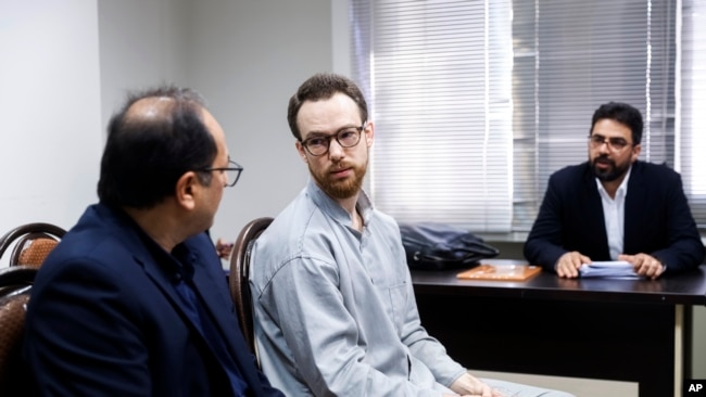 FILE - In this photo released by Mizan News Agency on Dec. 10, 2023, Swedish citizen Johan Floderus, center, sits at a courtroom at the Revolutionary Court in Tehran, Iran.