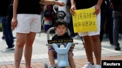 A family participates in a protest rally titled "Guard Our Children's Future" at Edinburgh Place in Hong Kong, Aug. 10, 2019. 