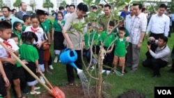 FILE: Lao Prime minister Thongloun Sisoulith plant a tree to commemorate Children Day in 2017