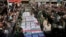 Flag-draped caskets of those who died in Saturday's terror attack on a military parade are laid out during a mass funeral, in the southwestern city of Ahvaz, Iran, Sept. 24, 2018. 