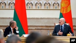 Belarusian President Alexander Lukashenko, right, delivers a speech as Chairman of the Munich Security Conference Wolfgang Ischinger, left, looks on during the Munich Security Conference Core Group meeting in Minsk, Oct. 31, 2018. 