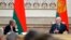 Belarusian President Alexander Lukashenko, right, delivers a speech as Chairman of the Munich Security Conference Wolfgang Ischinger, left, looks on during the Munich Security Conference Core Group meeting in Minsk, Oct. 31, 2018. 