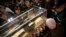 People stand around the mortal remains of Saint Pio (Padre Pio) as they are displayed in Rome's San Lorenzo Basilica, as part of the Roman Catholic Church 2016 Holy Year celebrations, Feb. 3, 2016.