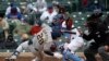 Milwaukee Brewers&#39; Daniel Robertson (28) is hit on the head by a pitch as Chicago Cubs catcher Willson Contreras reaches for the ball during the ninth inning of a baseball game in Chicago, Illinois, April 25, 2021.