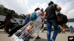 FILE - Venezuelan citizens arrive at the La Parada neighborhood of Cucuta, Colombia, on the border with Venezuela, Feb. 23, 2018.