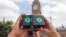 A man looks through a virtual reality device that shows a 360-degree view of the city of Aleppo, Syria, during an Amnesty International protest in Parliament Square, London, July 11, 2015.