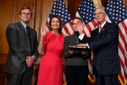FILE - House Speaker Nancy Pelosi of Calif., second from left, poses during a ceremonial swearing-in with Rep. Francis Rooney, R-Fla., right, on Capitol Hill in Washington, Jan. 3, 2019.