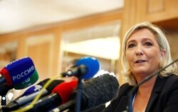 FILE - Leader of France's National Rally Party Marine Le Pen speaks during a news conference in Milan, Italy, May 18, 2019.